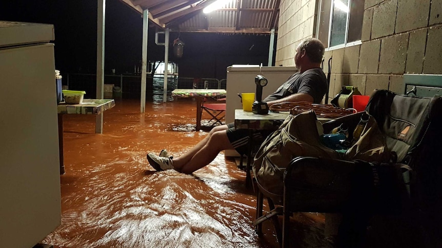 man on flooded porch