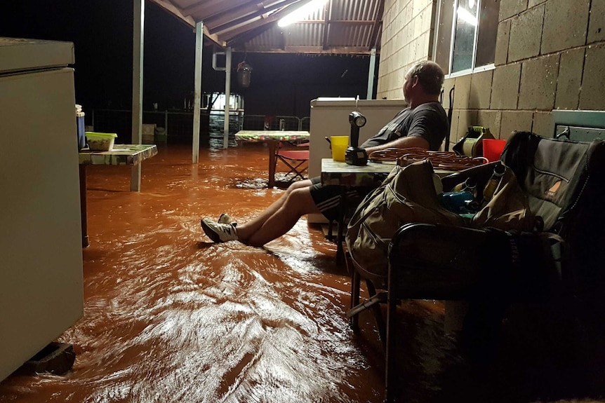 man on flooded porch