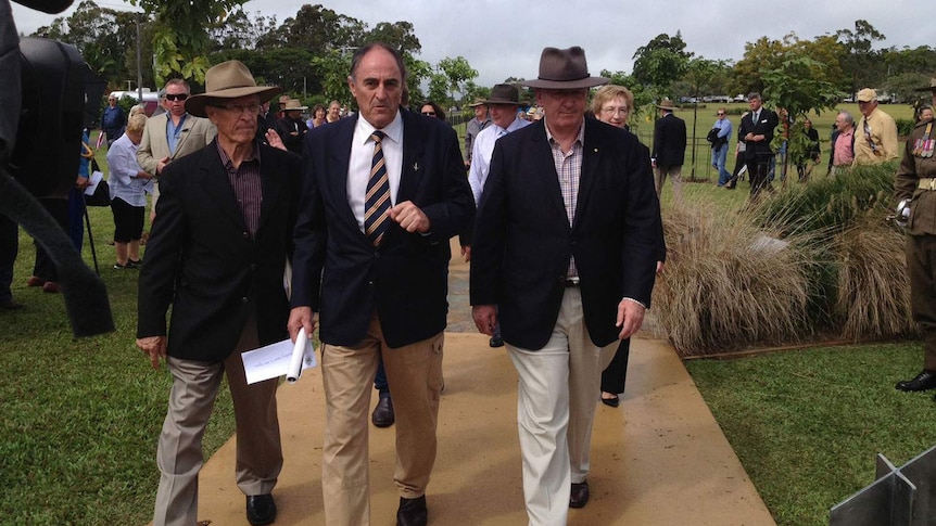 Governor-General Sir Peter Cosgrove (right), with Gordon Chuck (centre) walk down the Afghanistan Avenue of Honour at Yungaburra