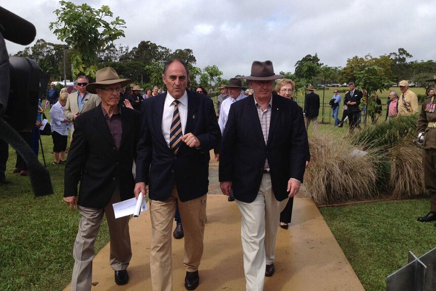 Governor-General Sir Peter Cosgrove (right), with Gordon Chuck (centre) walk down the Afghanistan Avenue of Honour at Yungaburra
