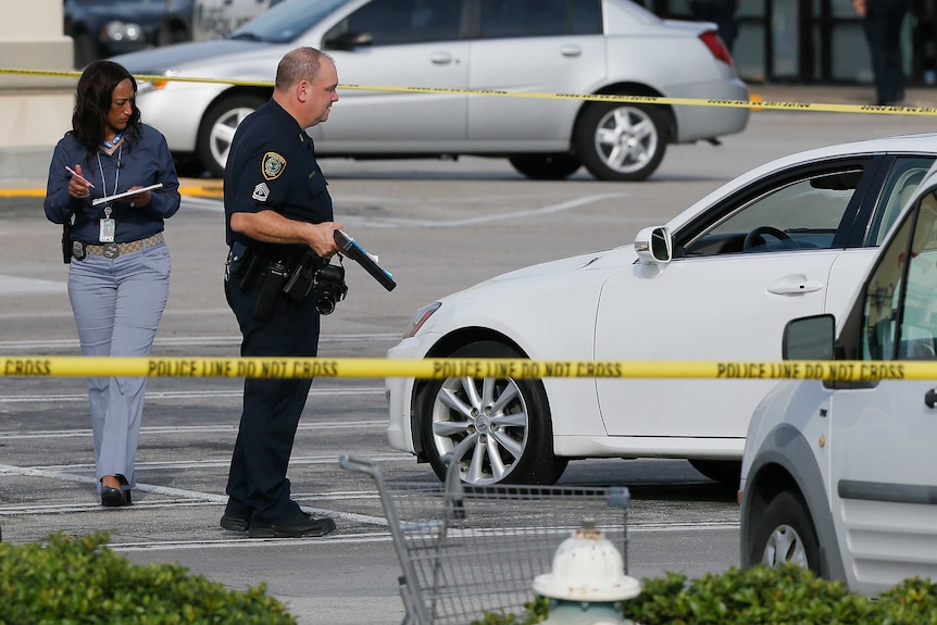 Houston Police investigators photograph a vehicle.