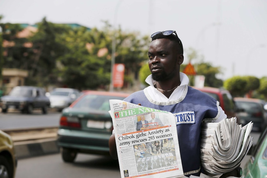 Man selling newspapers