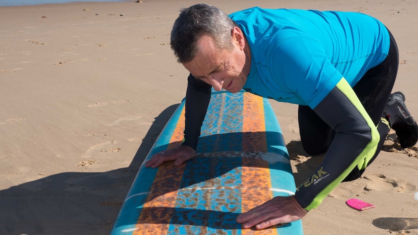 Neil Campbell applies his special board wax formula.