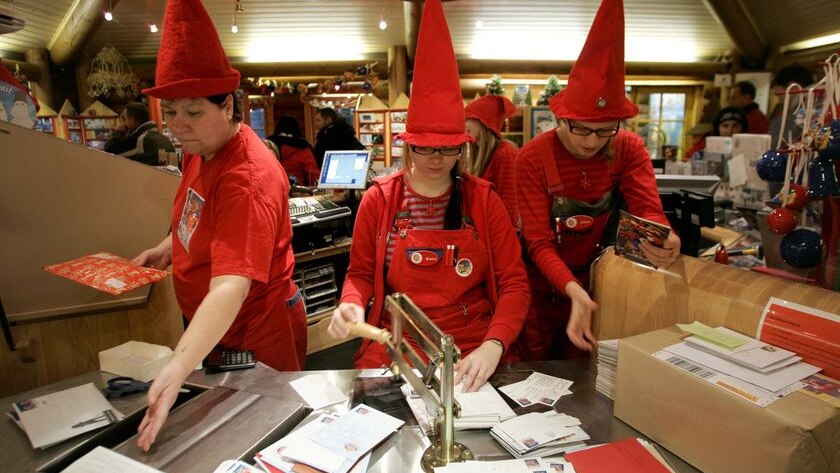 People dressed as elves post mark letters