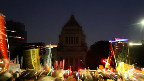 Crowds gather for a demonstration outside parliament in Tokyo on July 29.
