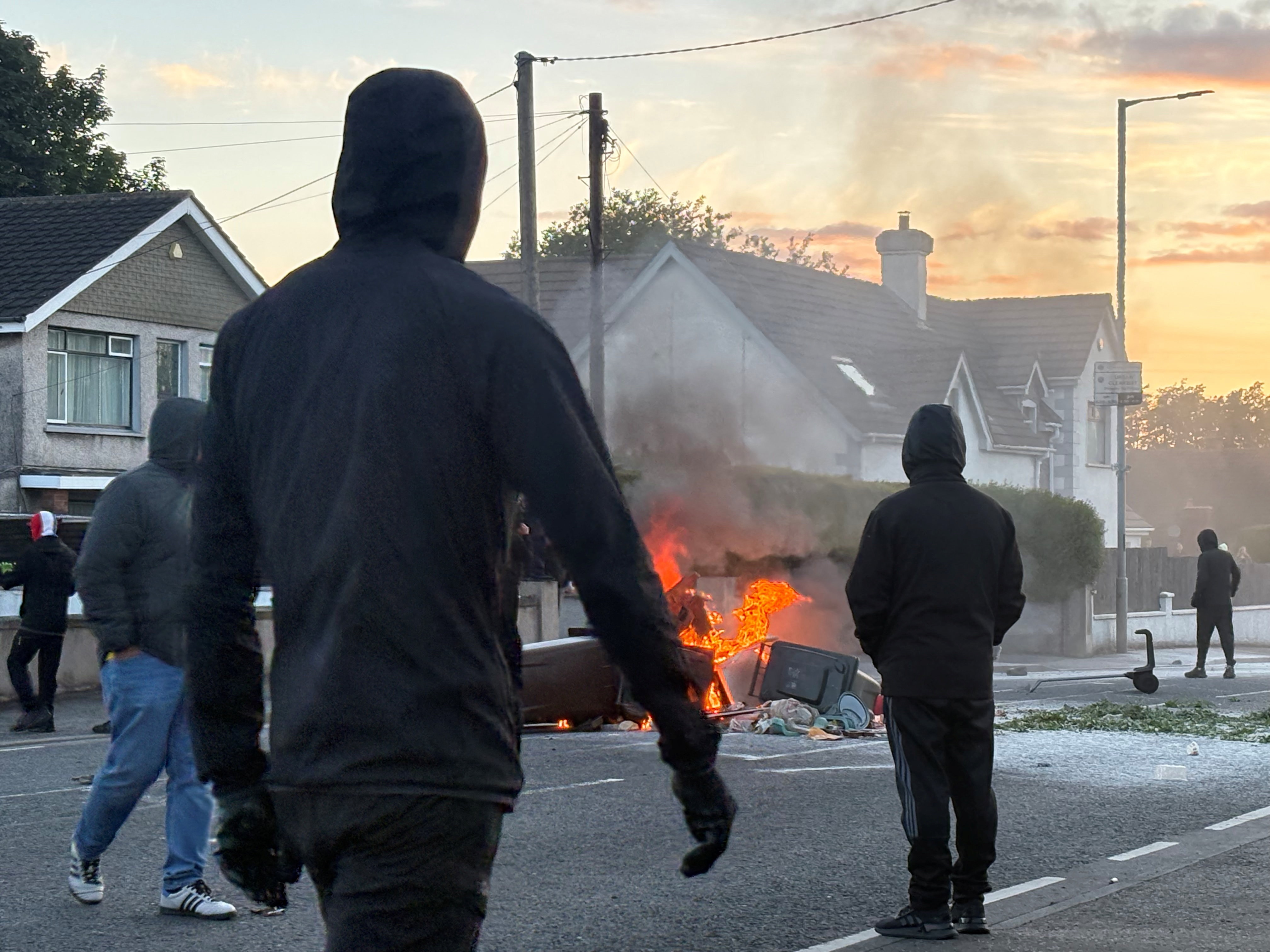 Stabbing victim's family calls for calm amid violent protests in Northern Ireland