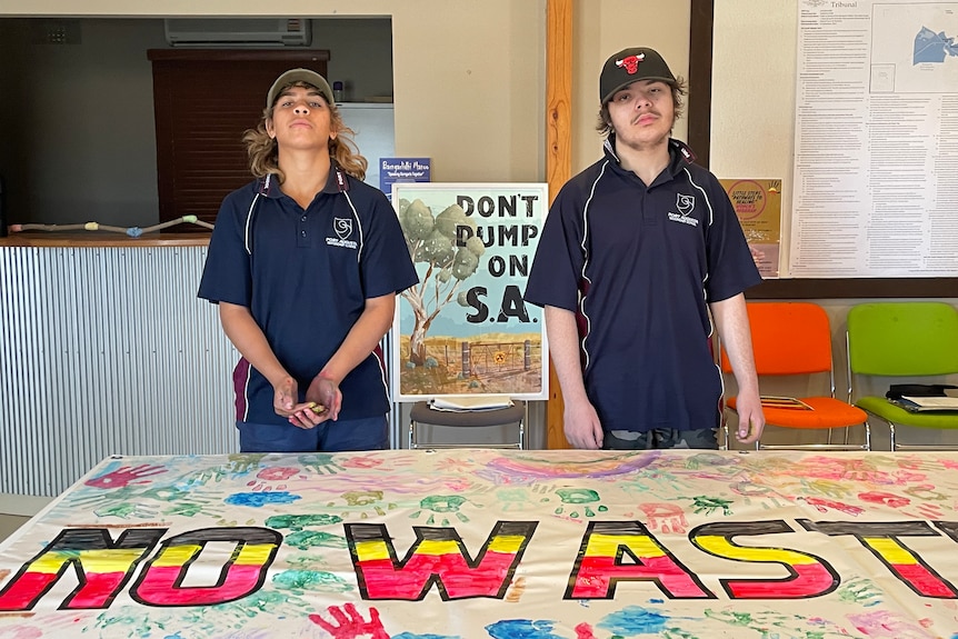 two boys behind a protest sign they painted