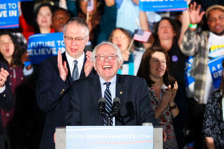 Bernie Sanders smiles after winning the New Hampshire presidential primary