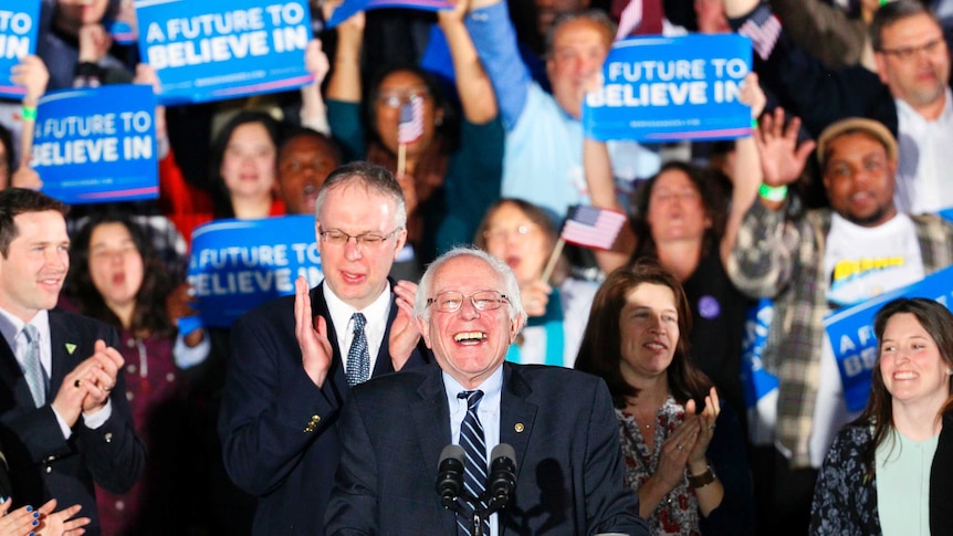 Bernie Sanders smiles after winning the New Hampshire presidential primary