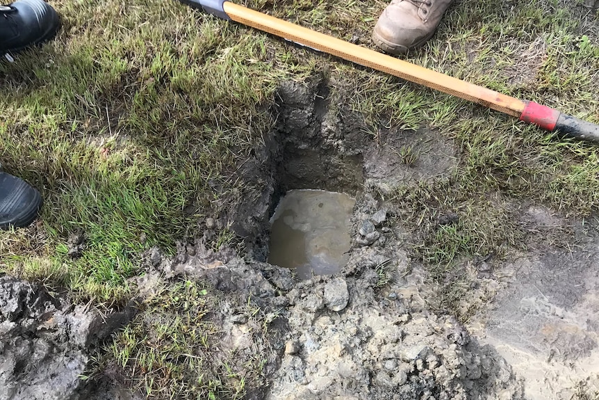 A hole in the ground filled with water.