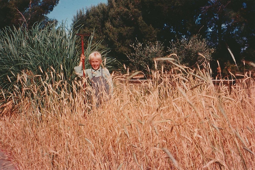 An old photo of a young child in a garden