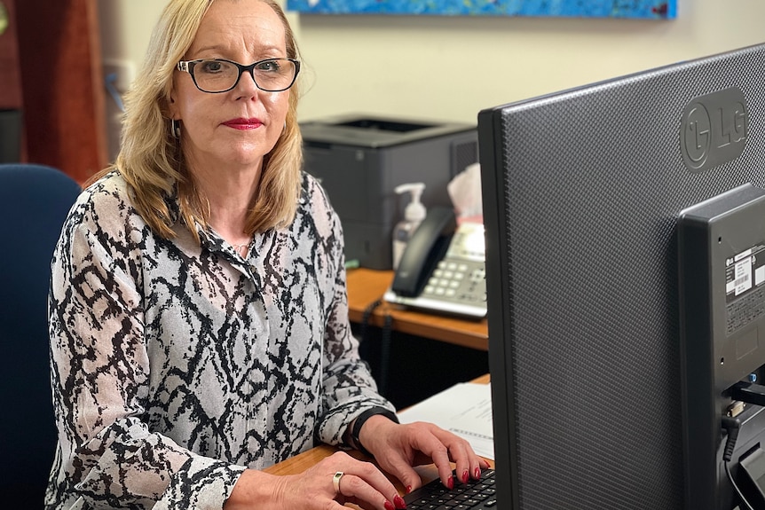 Liz Brown using a computer in an office.