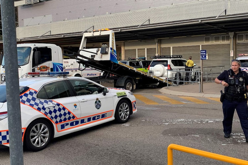 A white four-wheel-drive is towed away from Townsville hospital as part of a police investigation on November 27, 2020.