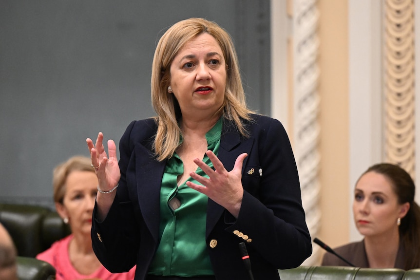 queensland premier annastacia palaszczuk gestures with both hands while speaking in parliament