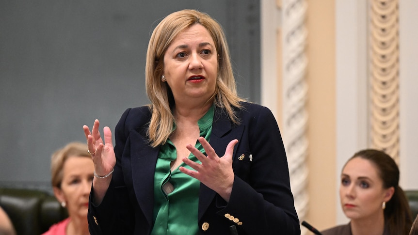 queensland premier annastacia palaszczuk gestures with both hands while speaking in parliament