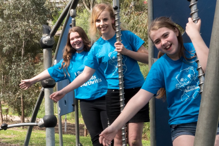 Emily Hoare, Sarah Hammond and Lucy Hoare swing on a playground.