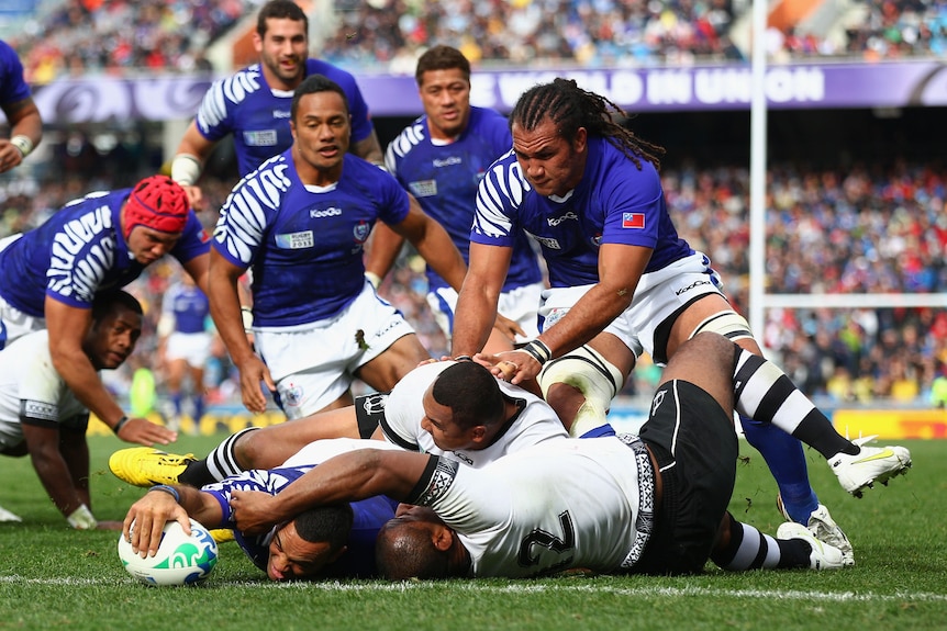 Samoa's Kahn Fotuali'i stretches out to score with team-mates behind him