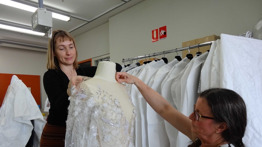 Artlab conservators undertake the finnicky work to fit a Paolo Sebastian creation to a mannequin.