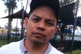 A Filipino man in a baseball cap looking at the camera.