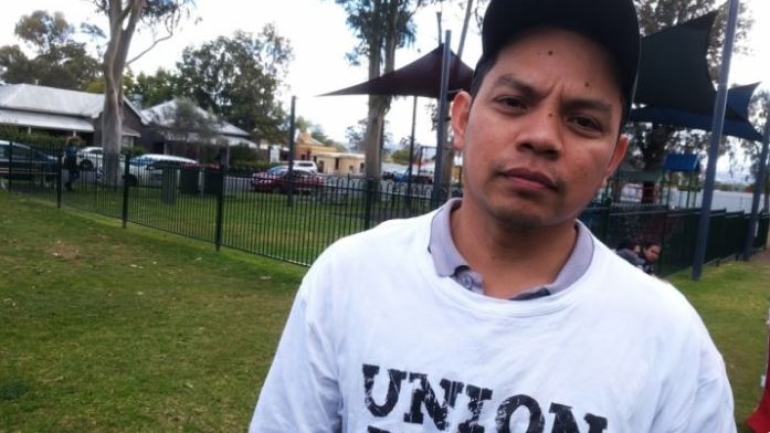 A Filipino man in a baseball cap looking at the camera.