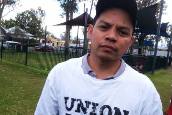 Filipino man in a baseball cap looking at the camera