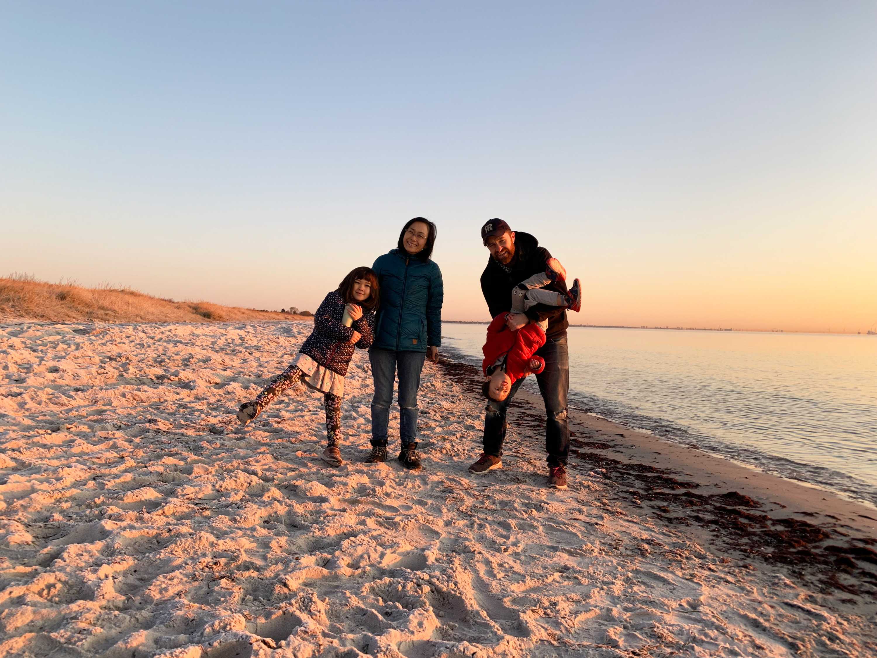 David Stuart with his wife and two children on a Denmark beach at sunrise.
