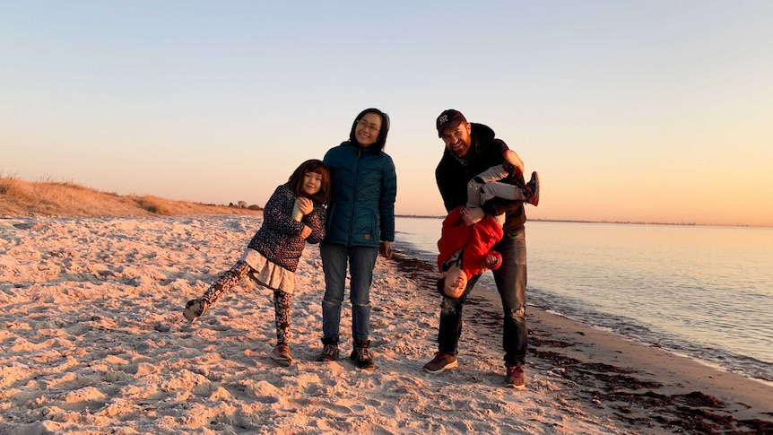 David Stuart with his wife and two children on a Denmark beach at sunrise.
