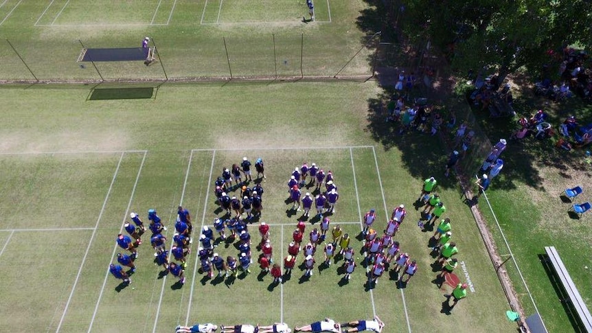 Residents spell out Novak with their bodies.