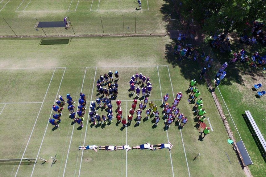 Residents spell out Novak with their bodies.