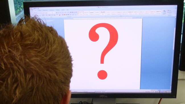 back of head and computer screen with question mark