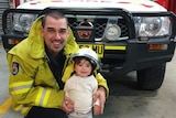 A firefighter with a little girl.