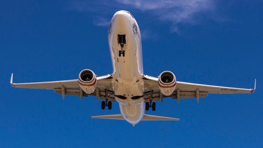 Plane flies over Hobart Airport