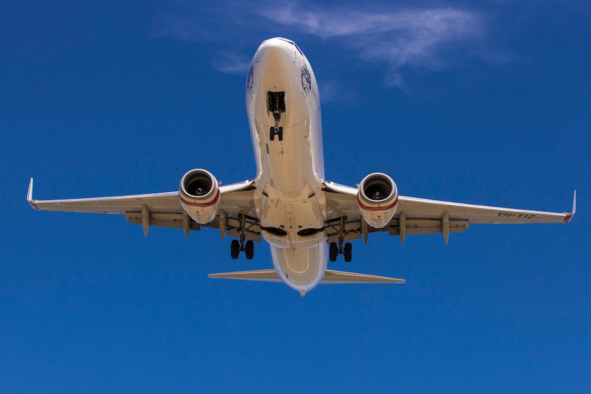 A plane flying in a blue sky.