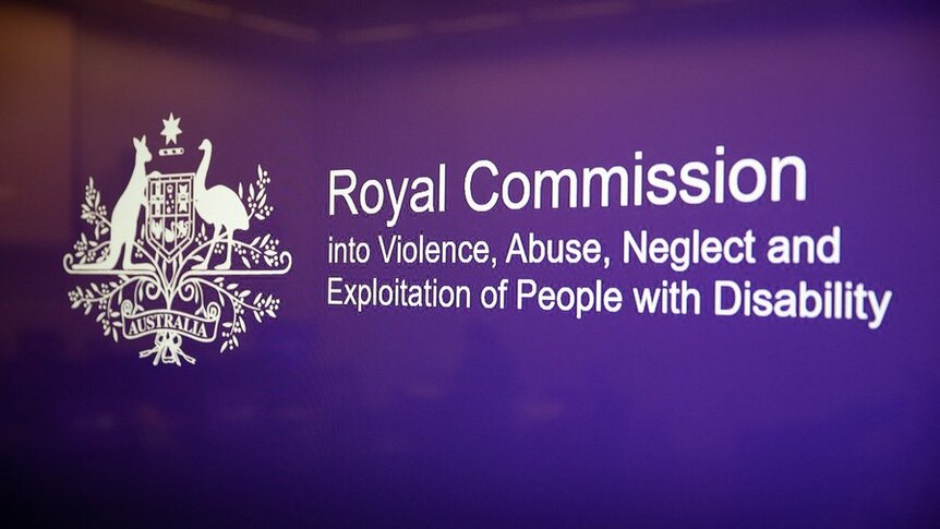 Deep purple sign with the title 'Royal Commission into Violence, Abuse, Neglect and Exploitation of People with Disability'