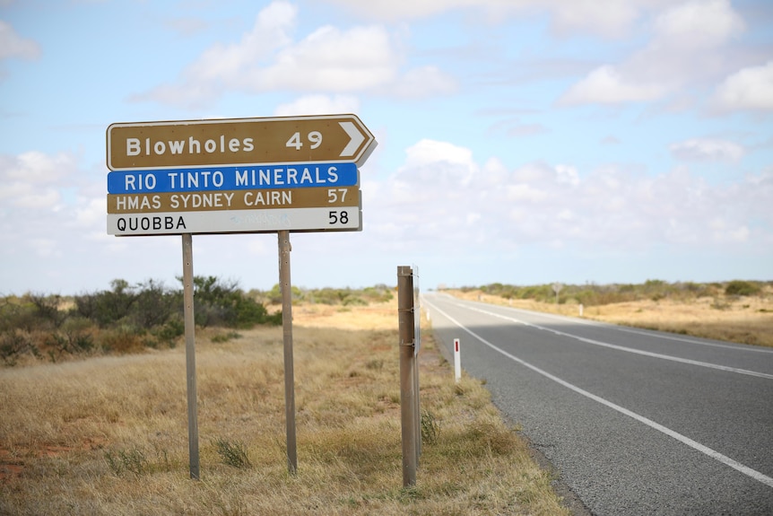 A sign on the side of the road pointing to the Blowholes campsite