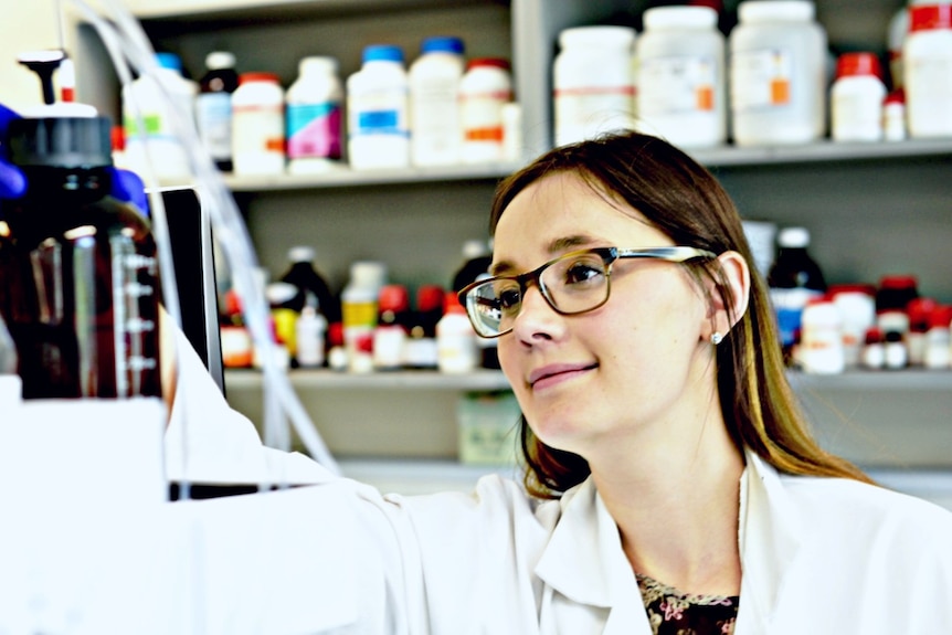 Scientist looks at instruments in a lab