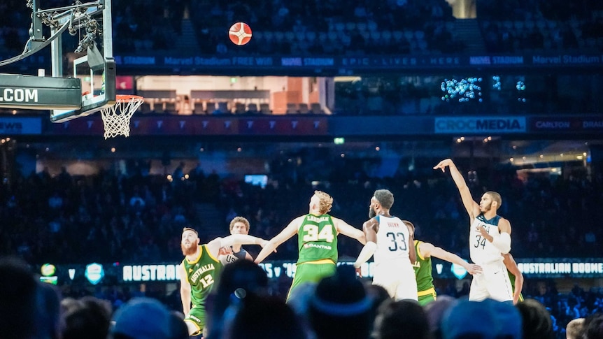 Jayson Tatum is seen from the crowd shooting a free throw in an exhibition match between Australia and USA.