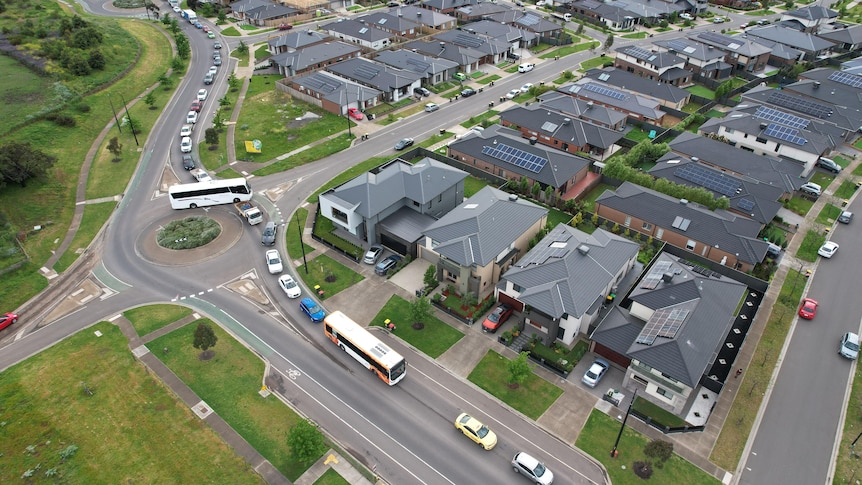 An aerial view of cars packed into a suburban development.
