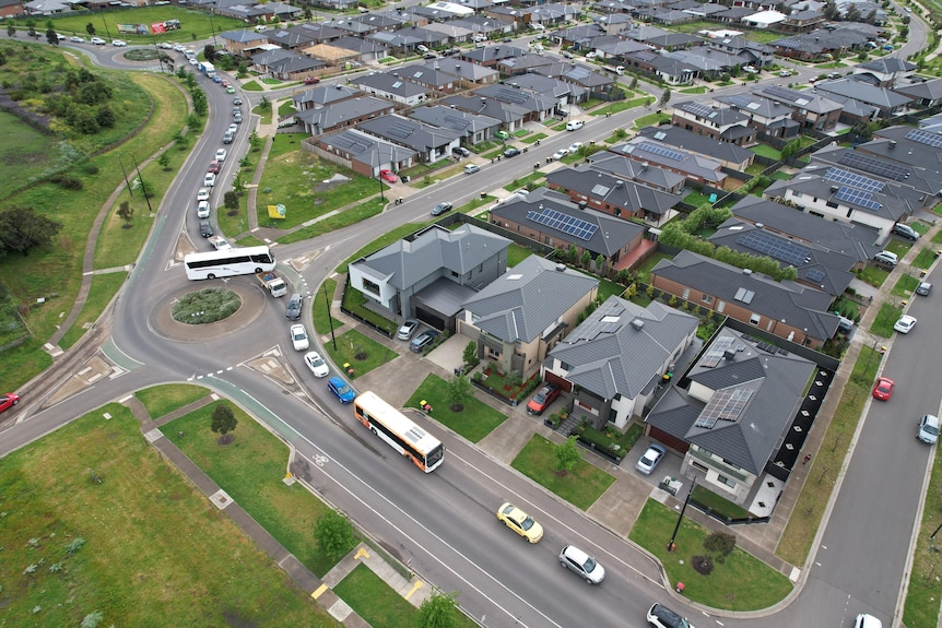 An aerial view of cars packed into a suburban development.