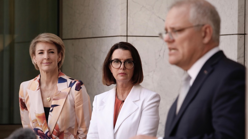 Michaelia Cash and Anne Ruston looks on as Scott Morrison speaks at a press conference