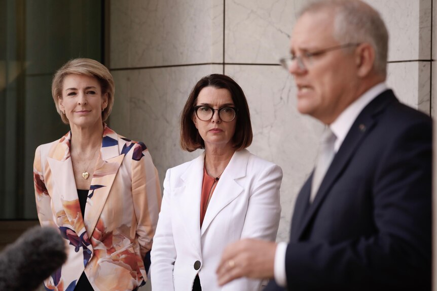 Michaelia Cash and Anne Ruston looks on as Scott Morrison speaks at a press conference