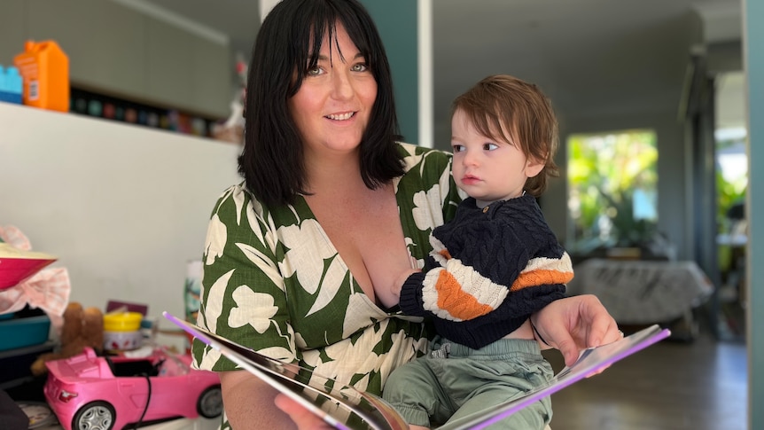 Woman with dark hair holding toddler son