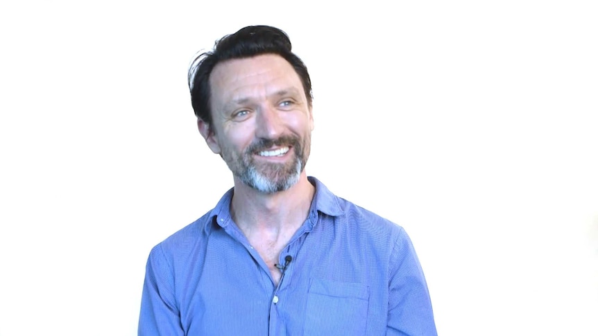 paul dempsey smiling on a white background