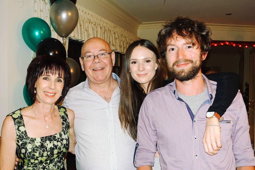 Nicola Trotman with her mum, dad and brother at a party