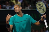 Nick Kyrgios reacts after losing a point against Roger Federer