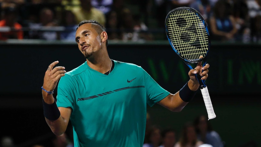 Nick Kyrgios reacts after losing a point against Roger Federer