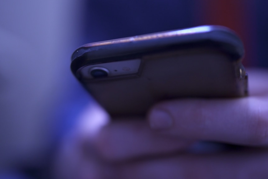 A man holds a mobile phone