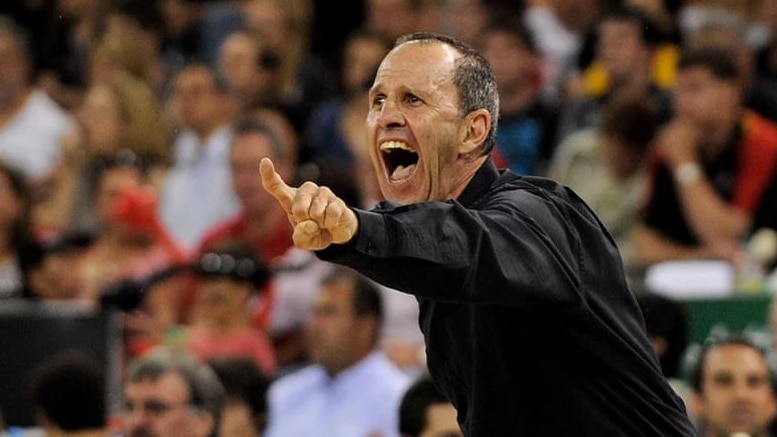 Brian Goorjian yells with his hand outstretched at a game.