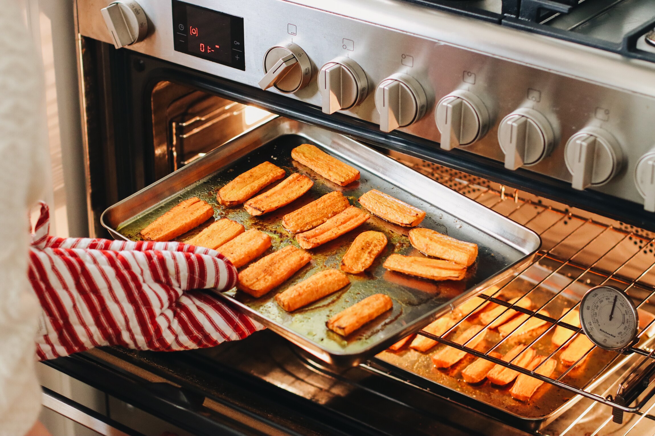 Tray of chunky spiced carrots going into an oven to be roasted, a simple recipe that can be enjoyed many ways.