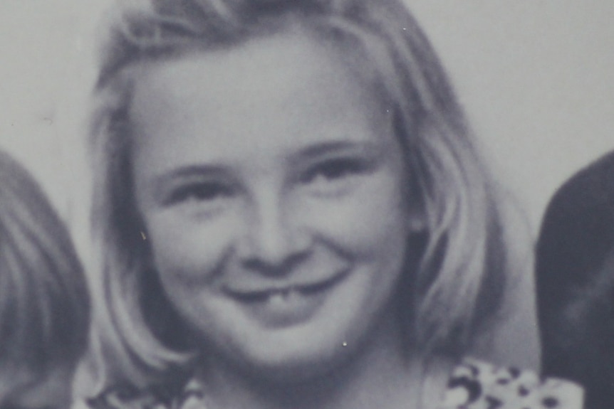 An old black and white photograph of a young fair-haired girl, probably from the early 70's. She's about 10